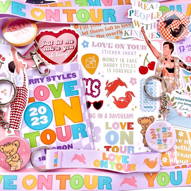 Harry Styles product collection including pins, keychains, stickers and more
